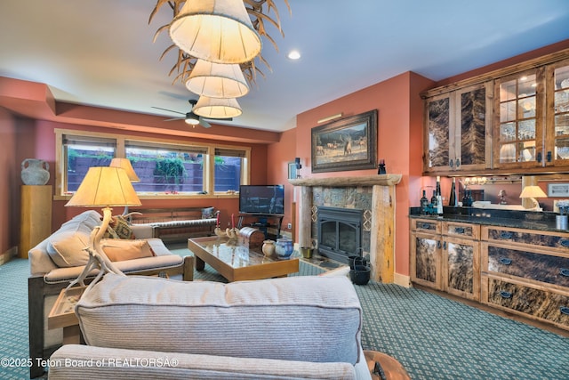 15 Kearsley Ln, Victor, ID 83455 - carpeted living room with a high end fireplace and ceiling fan