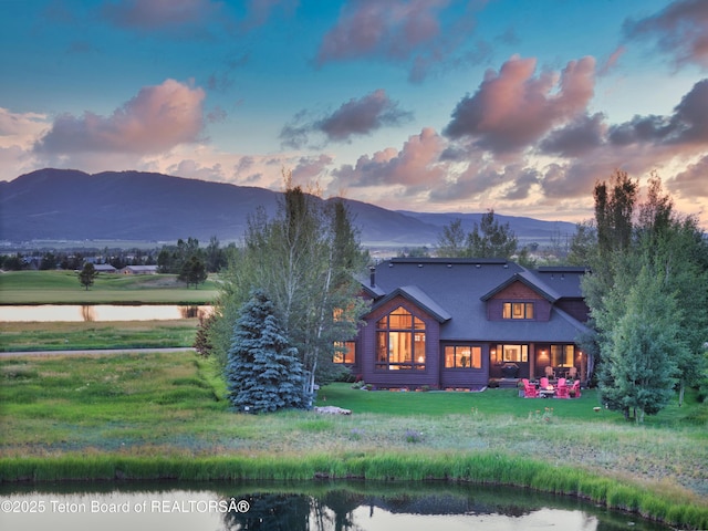 15 Kearsley Ln, Victor, ID 83455 - back of house at dusk featuring a water and mountain view and a yard