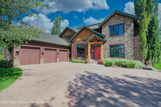 15 Kearsley Ln, Victor, ID 83455 - craftsman-style house featuring stone siding, driveway, and a garage