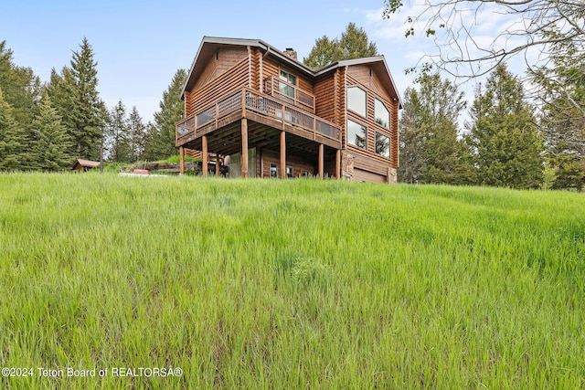 back of property featuring a chimney and a deck