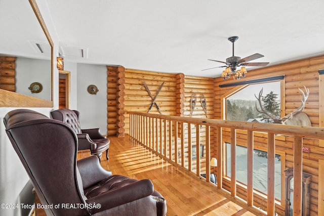 sitting room with ceiling fan and hardwood / wood-style flooring