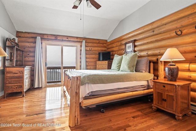 bedroom with a ceiling fan, lofted ceiling, wood-type flooring, access to outside, and log walls