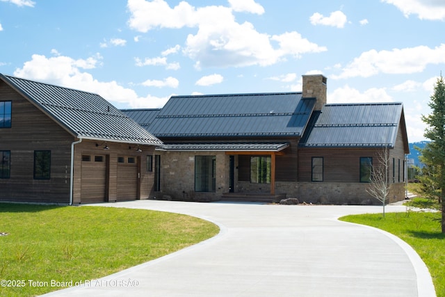 1105 Shasta Daisy Ct, Driggs, ID 83422 - view of front of property featuring a standing seam roof, curved driveway, a front yard, metal roof, and a chimney