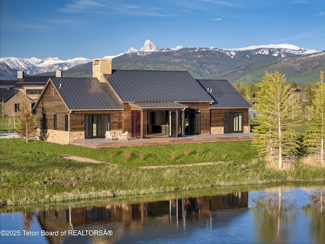 1105 Shasta Daisy Ct, Driggs, ID 83422 - back of house featuring a chimney, metal roof, a standing seam roof, and a lawn