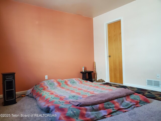 bedroom with carpet, visible vents, and baseboards