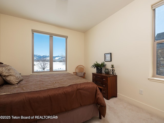 70 Baywood Dr, Driggs, ID 83422 - bedroom with baseboards, multiple windows, lofted ceiling, and light colored carpet
