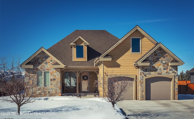 70 Baywood Dr, Driggs, ID 83422 - view of front facade with stone siding, a shingled roof, and driveway