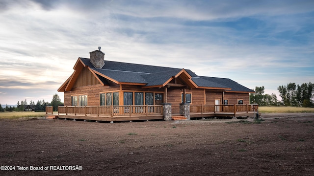 4660 Pale Morning Dr, Tetonia, ID 83452 - rear view of property featuring a deck, roof with shingles, and a chimney