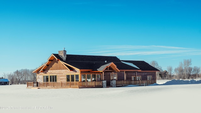 log home featuring a chimney