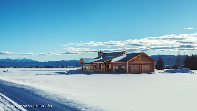 4660 Pale Morning Dr, Tetonia, ID 83452 - view of front of property featuring a chimney, an attached garage, and a mountain view