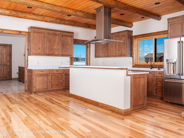 4660 Pale Morning Dr, Tetonia, ID 83452 - kitchen with island range hood, wooden ceiling, brown cabinets, light wood-style floors, and high end fridge