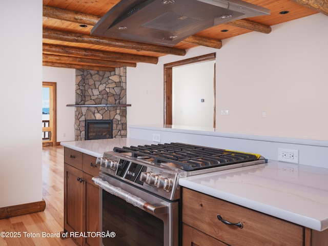4660 Pale Morning Dr, Tetonia, ID 83452 - kitchen featuring light wood finished floors, brown cabinetry, gas stove, wood ceiling, and ventilation hood