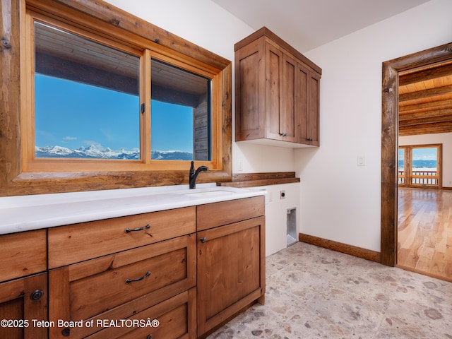 4660 Pale Morning Dr, Tetonia, ID 83452 - kitchen with baseboards, brown cabinets, a sink, and light countertops
