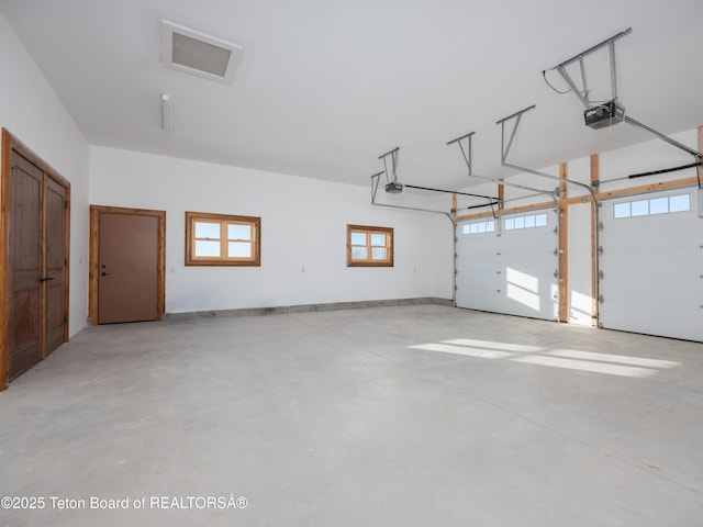 4660 Pale Morning Dr, Tetonia, ID 83452 - garage featuring baseboards and a garage door opener