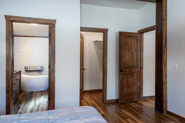 bedroom with wood finished floors and baseboards