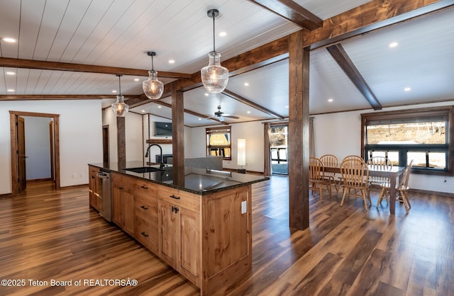 kitchen featuring dark wood-style floors, vaulted ceiling with beams, a center island with sink, a sink, and dishwasher