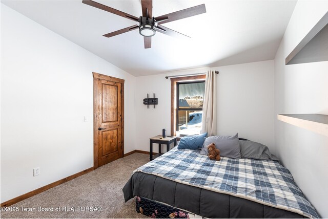 carpeted bedroom with vaulted ceiling, baseboards, and ceiling fan