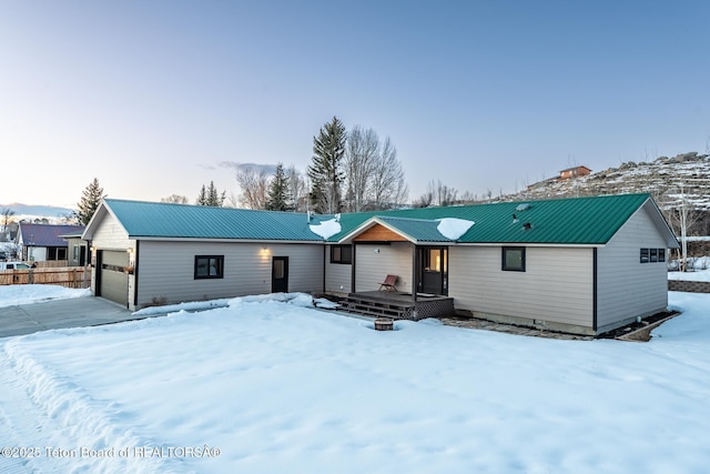 view of front of home with metal roof and a wooden deck