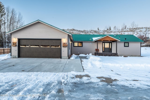 view of front of property with metal roof and an attached garage