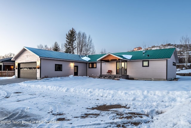 view of front of home featuring a garage and metal roof