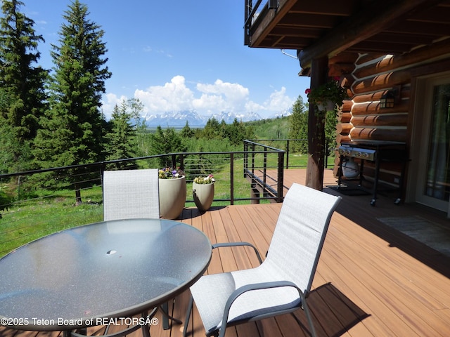 wooden deck with outdoor dining space