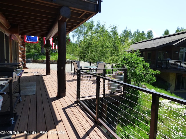 wooden deck featuring outdoor dining space