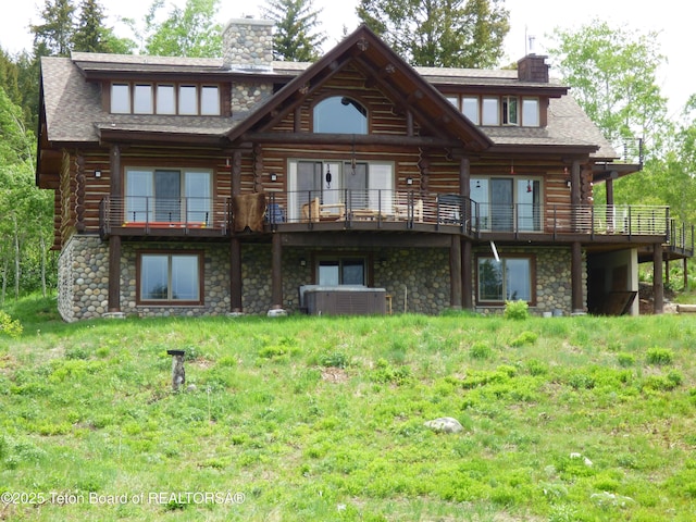 back of house with log exterior, a chimney, stone siding, and central air condition unit