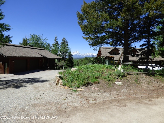 view of side of home featuring gravel driveway