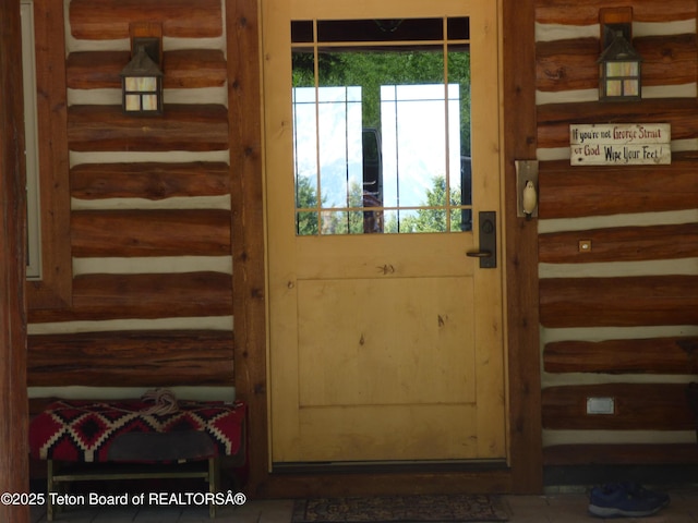 entryway with rustic walls