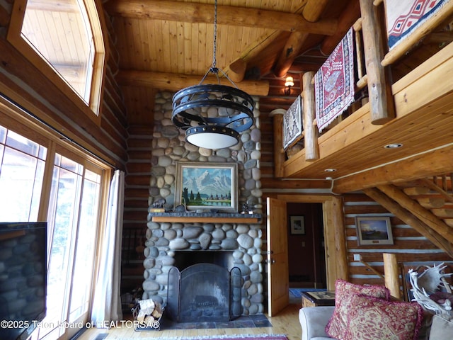 living area featuring a fireplace, wood finished floors, wood ceiling, a towering ceiling, and beam ceiling