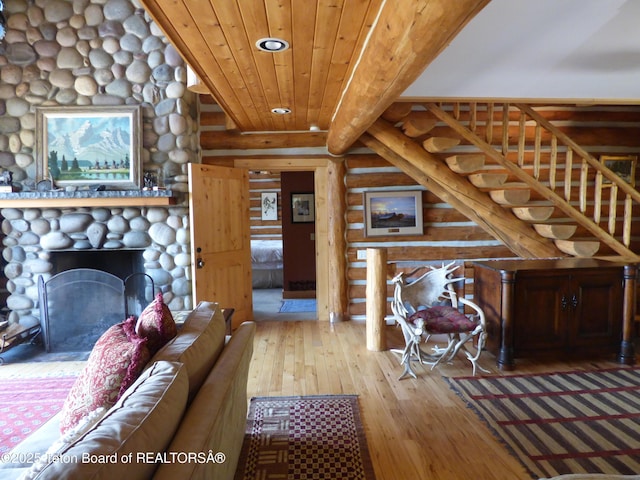 living area with wooden ceiling, a fireplace, and hardwood / wood-style floors