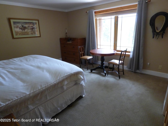 bedroom featuring carpet floors, ornamental molding, and baseboards