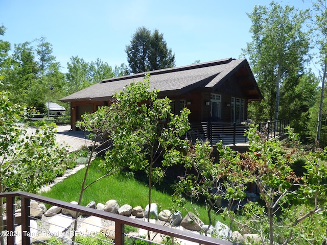 view of property exterior featuring a shingled roof