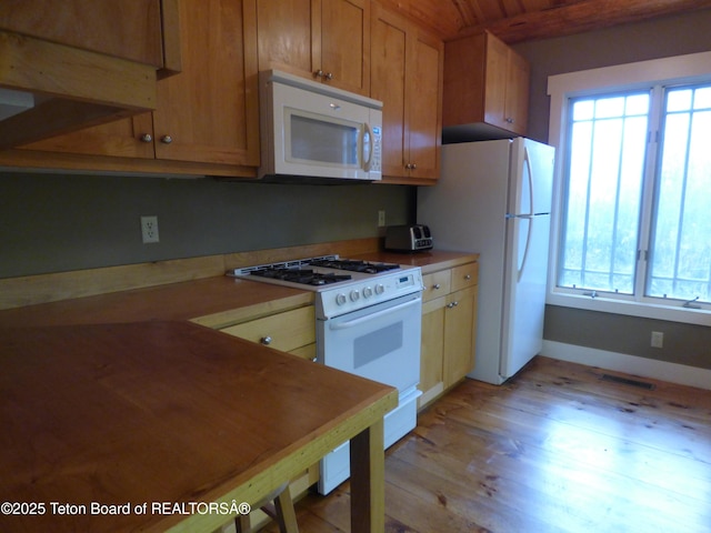 kitchen with visible vents, white appliances, plenty of natural light, and light wood-style flooring