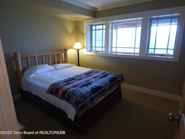 bedroom featuring multiple windows, baseboards, and crown molding