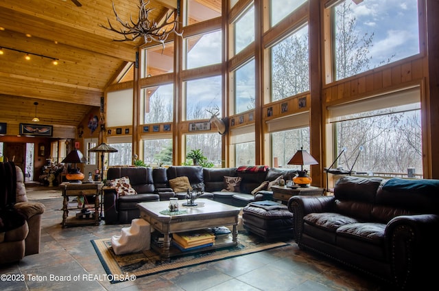 living room with high vaulted ceiling, wooden ceiling, and an inviting chandelier