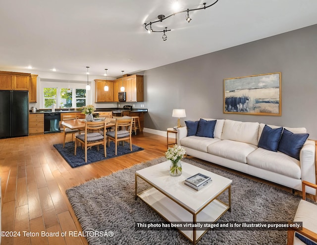 living area with light wood finished floors, recessed lighting, and baseboards