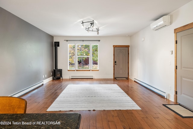 interior space featuring a baseboard radiator, hardwood / wood-style floors, baseboard heating, and a wall mounted AC