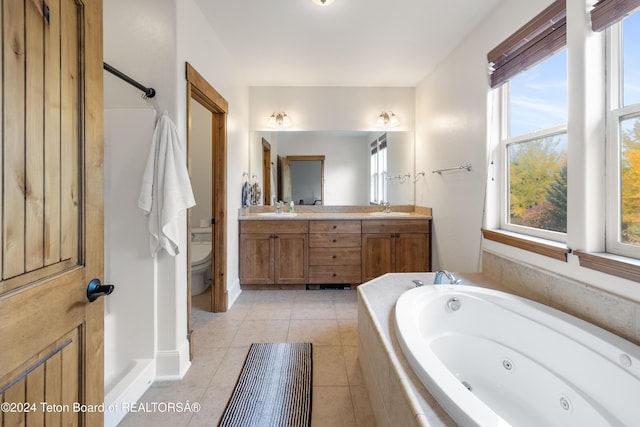 full bathroom featuring tile patterned flooring, toilet, vanity, and a tub with jets