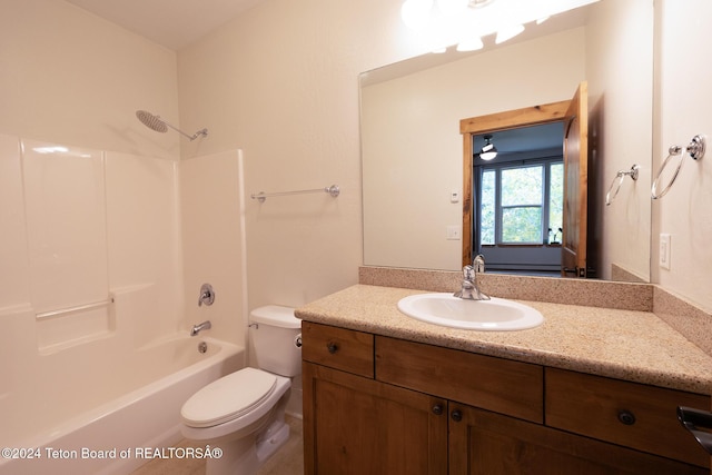 bathroom featuring shower / washtub combination, vanity, and toilet