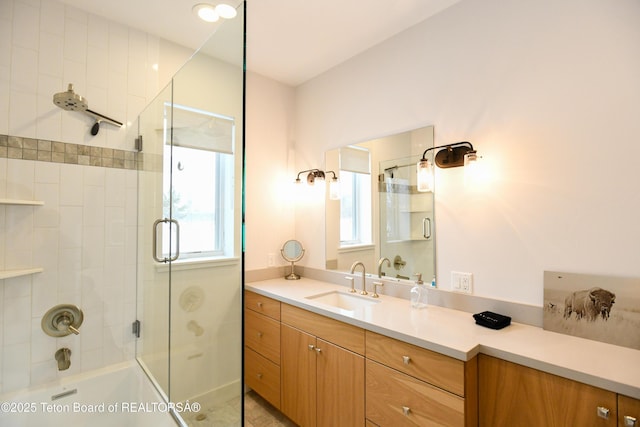 full bath featuring bath / shower combo with glass door and vanity