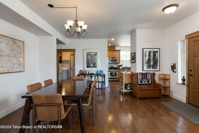 dining room with an inviting chandelier, baseboards, and dark wood finished floors