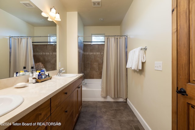 bathroom featuring shower / tub combo, visible vents, a sink, and tile patterned floors