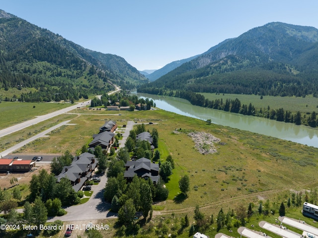 bird's eye view with a water and mountain view