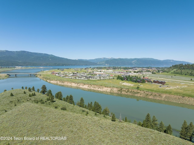 birds eye view of property with a water and mountain view