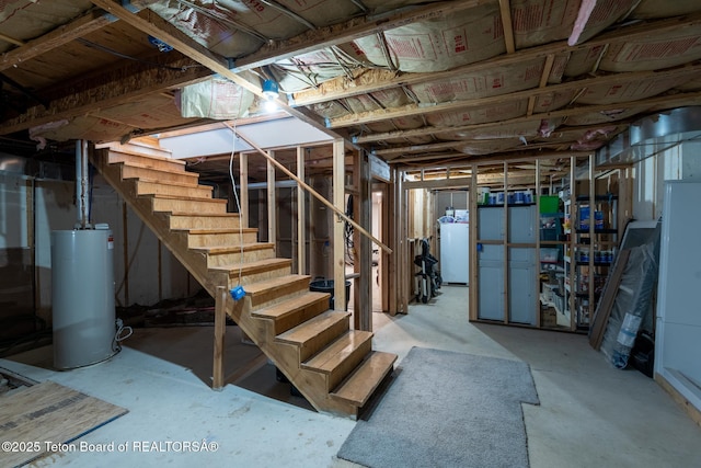 unfinished below grade area with stairs, water heater, and washer / clothes dryer