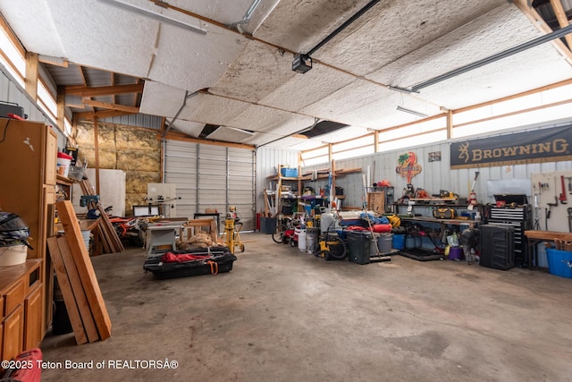 garage with a workshop area and metal wall