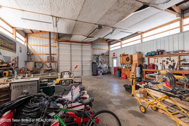 garage featuring a workshop area and metal wall