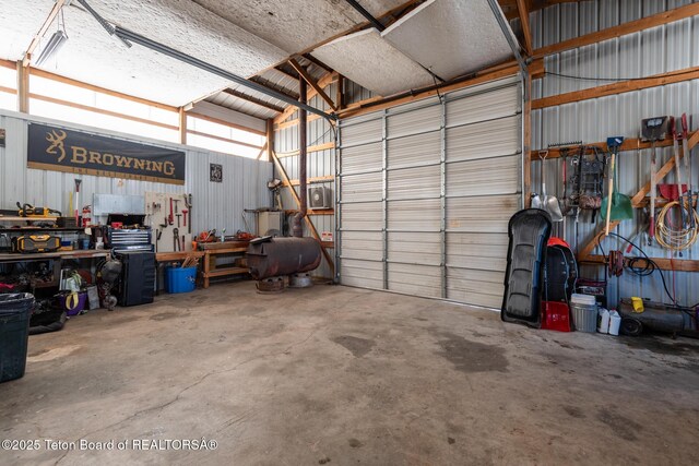 garage with metal wall and a workshop area