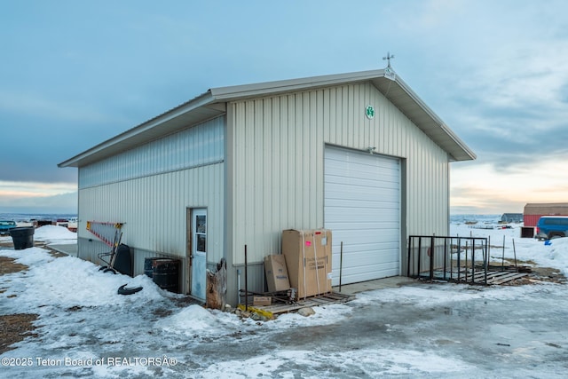 snow covered structure featuring an outdoor structure